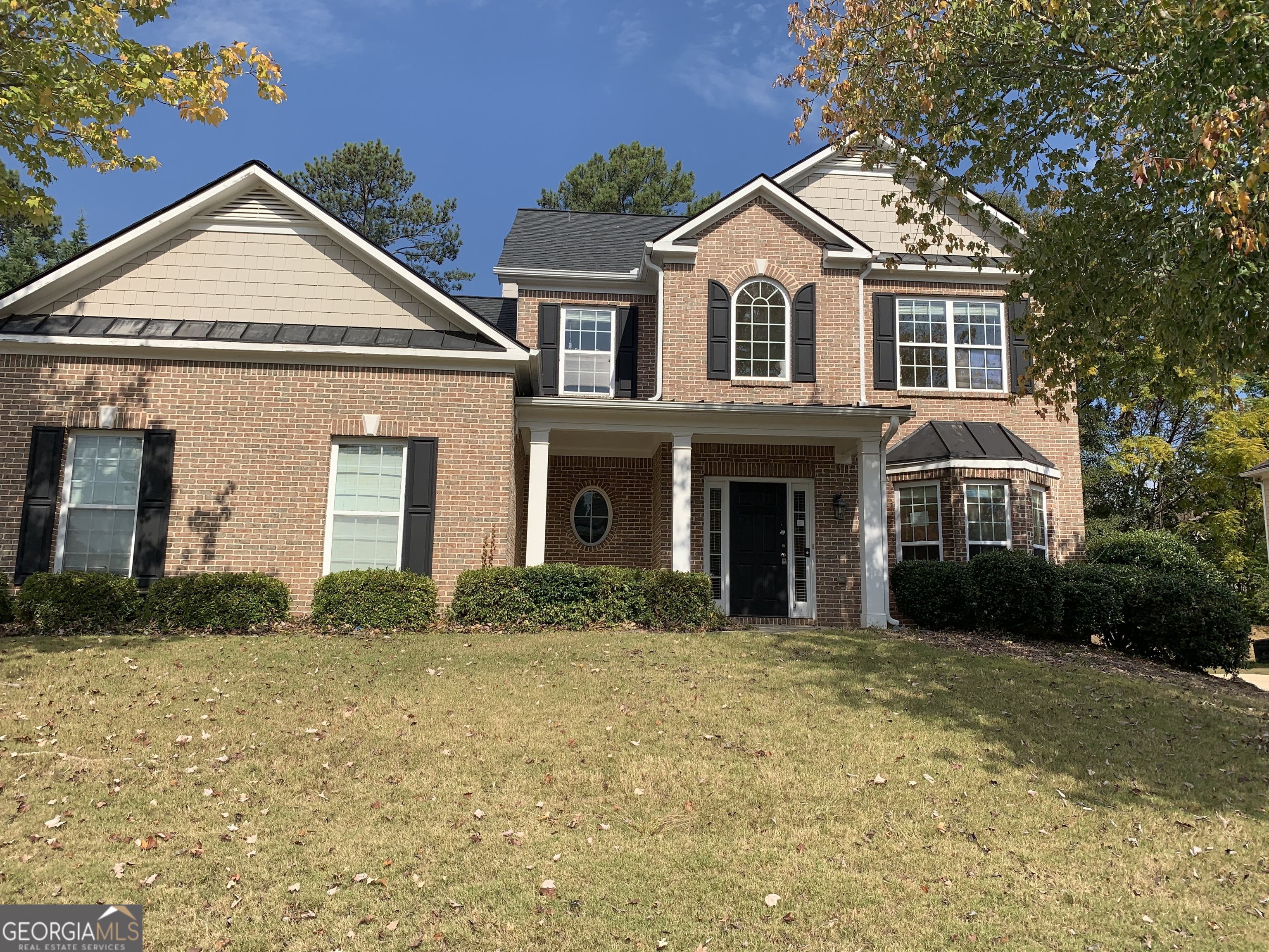 a front view of a house with a yard