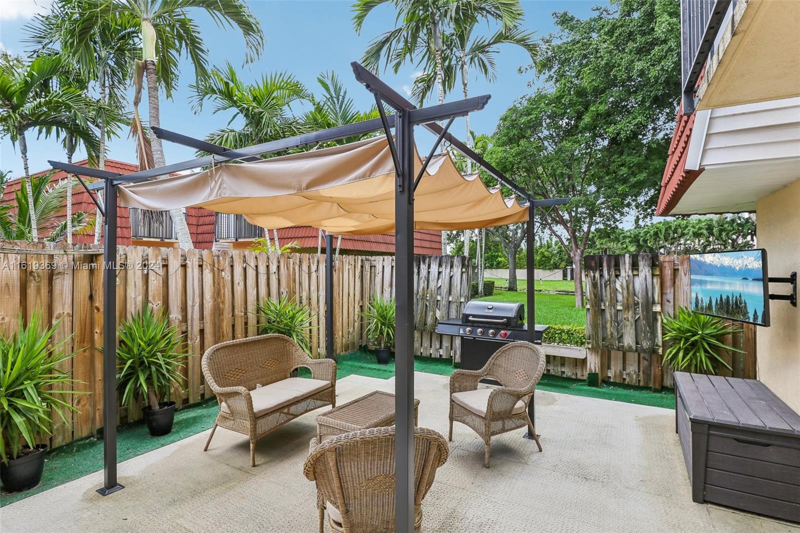 a view of a patio with a table and chairs and potted plants