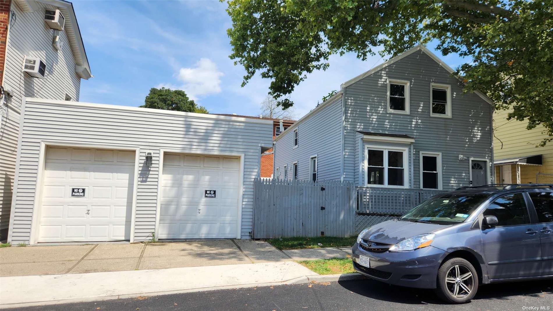 a front view of a house with parking space