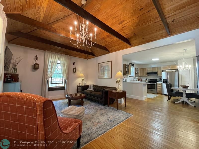 a living room with furniture and wooden floors