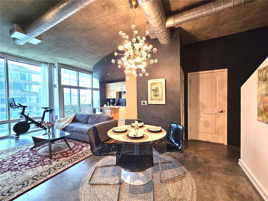 a view of a dining room with furniture a chandelier and wooden floor