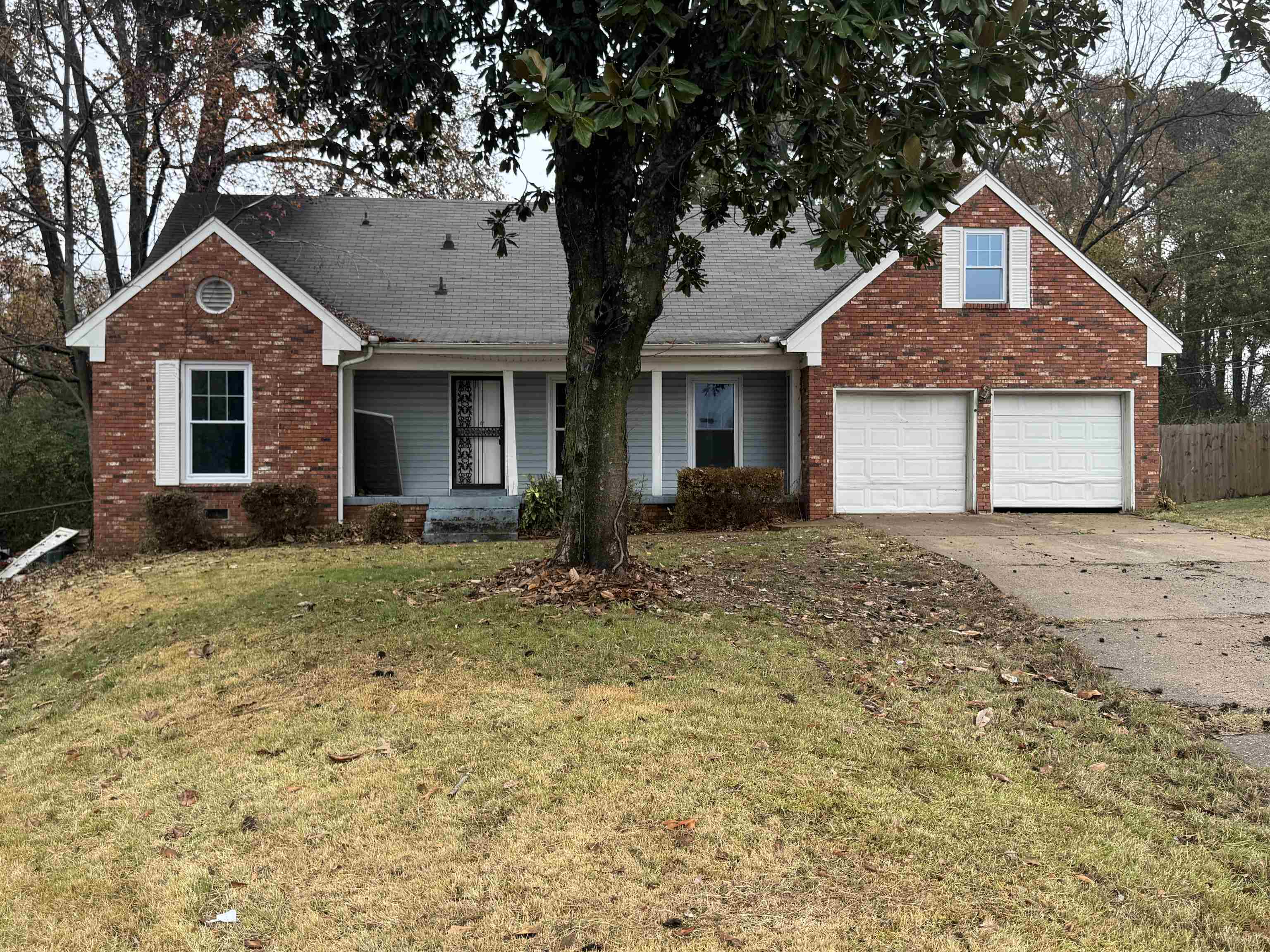 View of front of property featuring a front yard and a garage