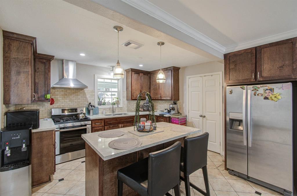 a kitchen with a refrigerator a stove a sink and a refrigerator