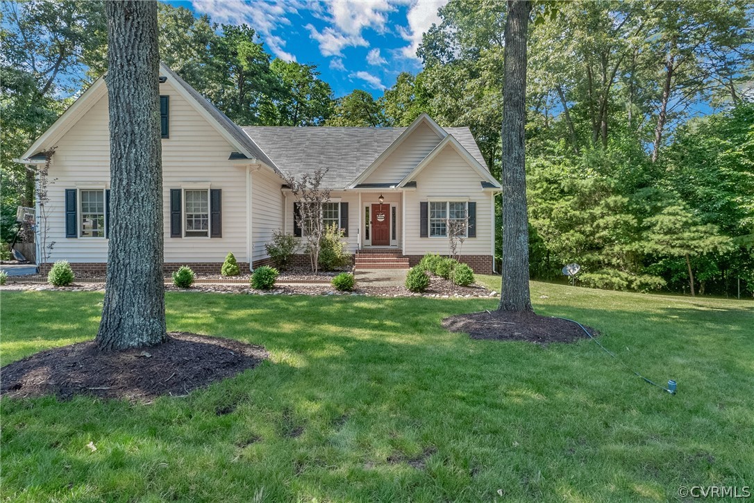 a front view of house with a garden