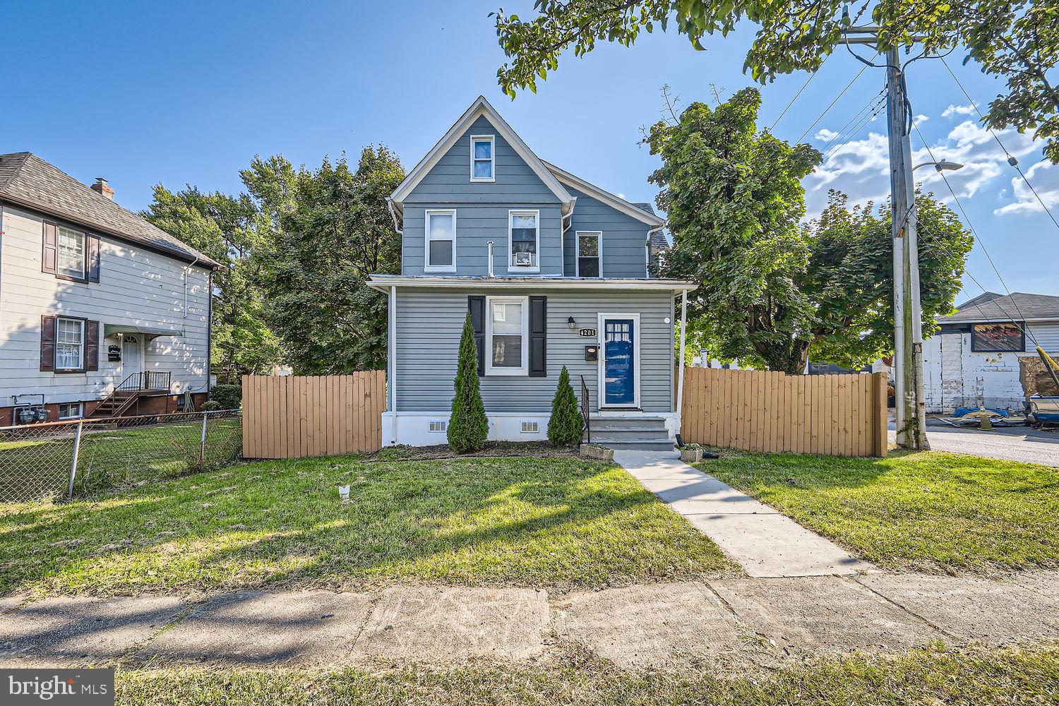 a view of a house with a yard and a patio