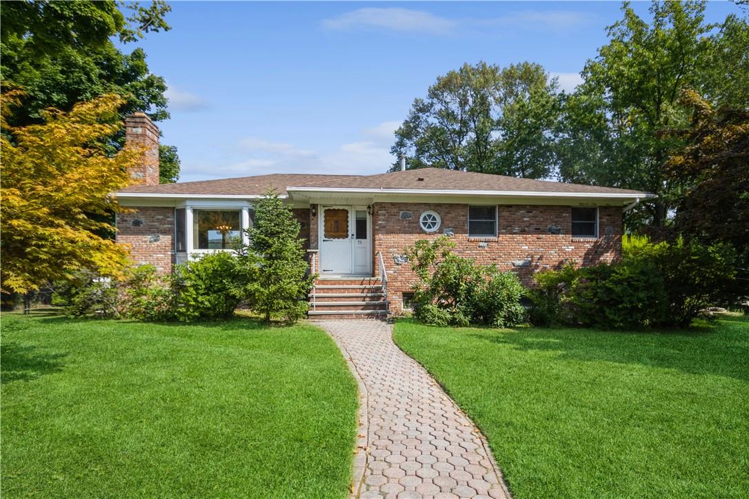 a front view of house with yard and green space