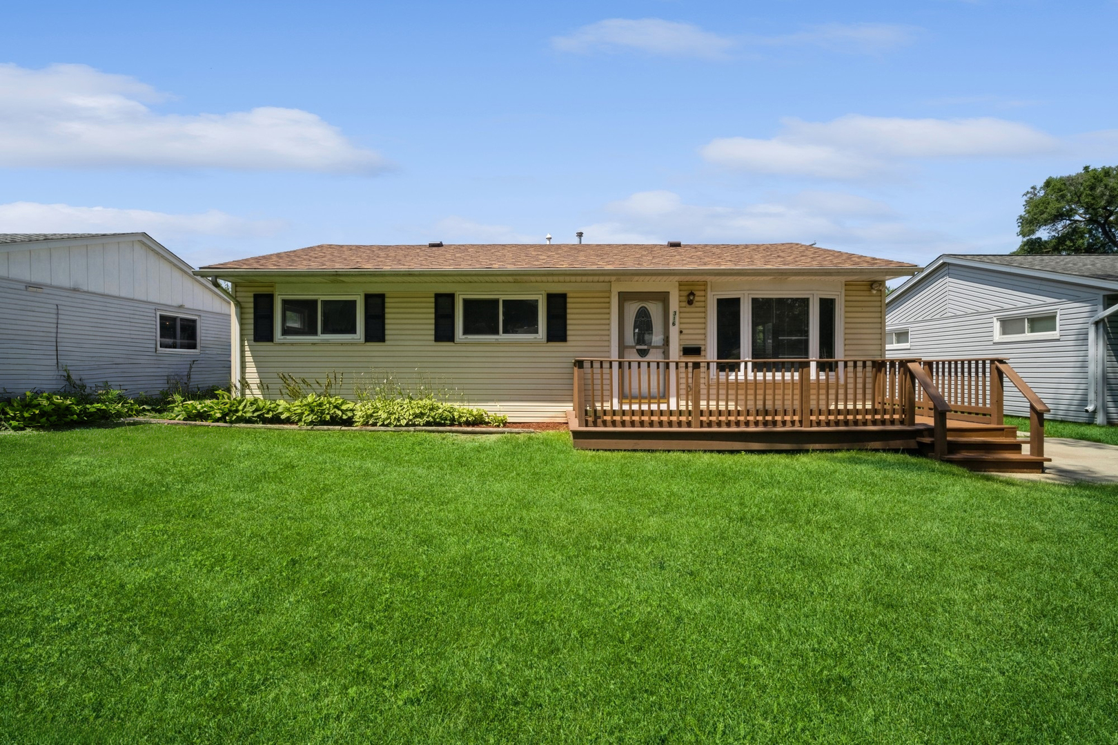 a front view of house with yard and green space