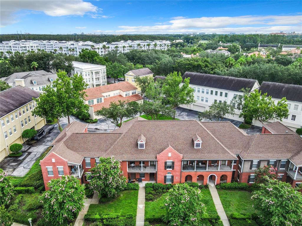 an aerial view of multiple houses with a yard