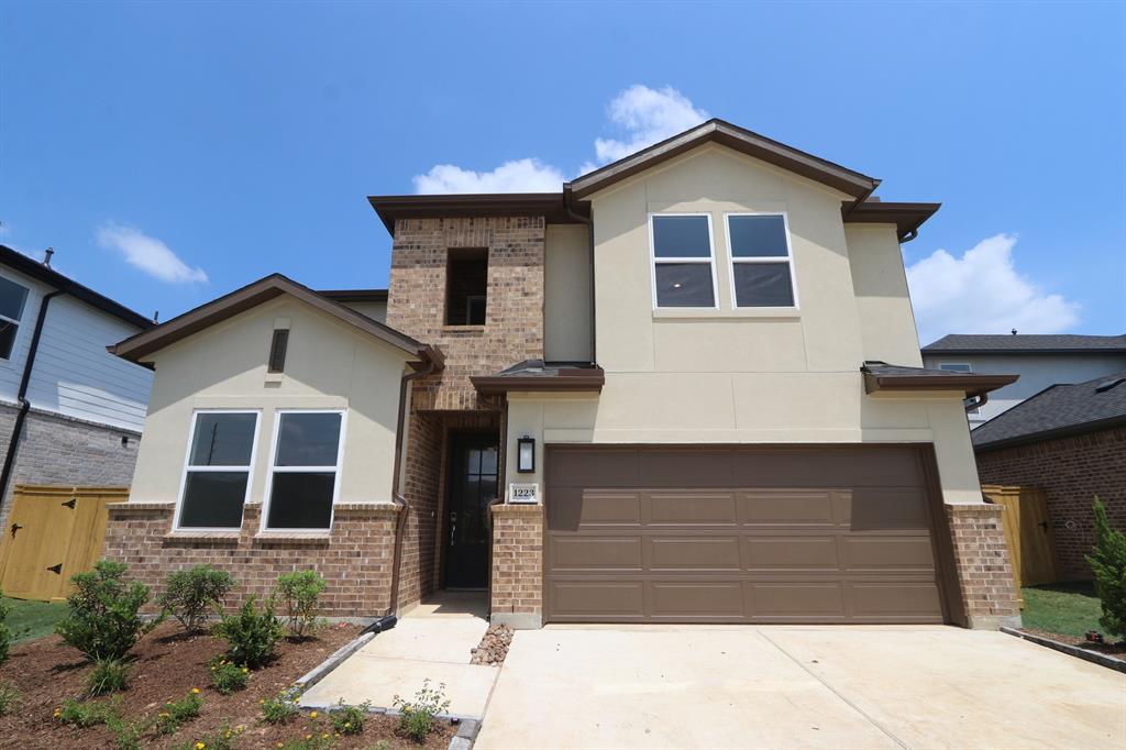 a front view of a house with a garage