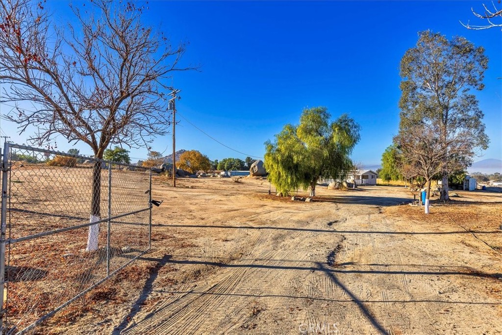 a view of a yard with wooden fence