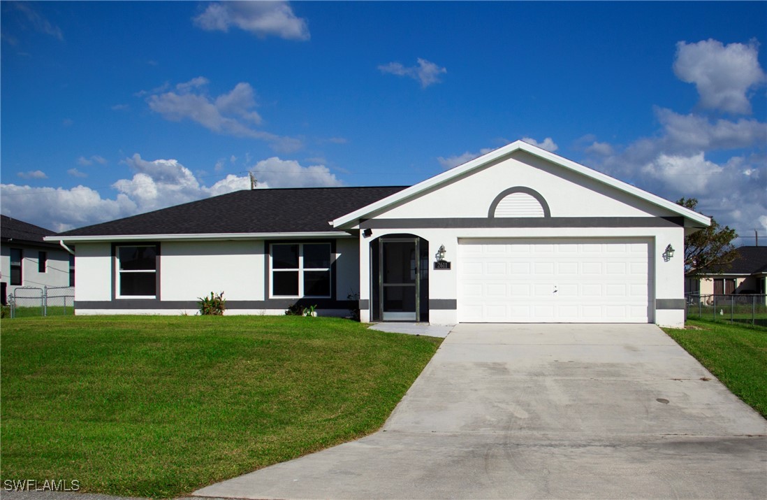 a front view of a house with a yard and garage