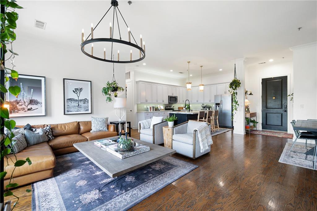 a living room with furniture a rug and a chandelier