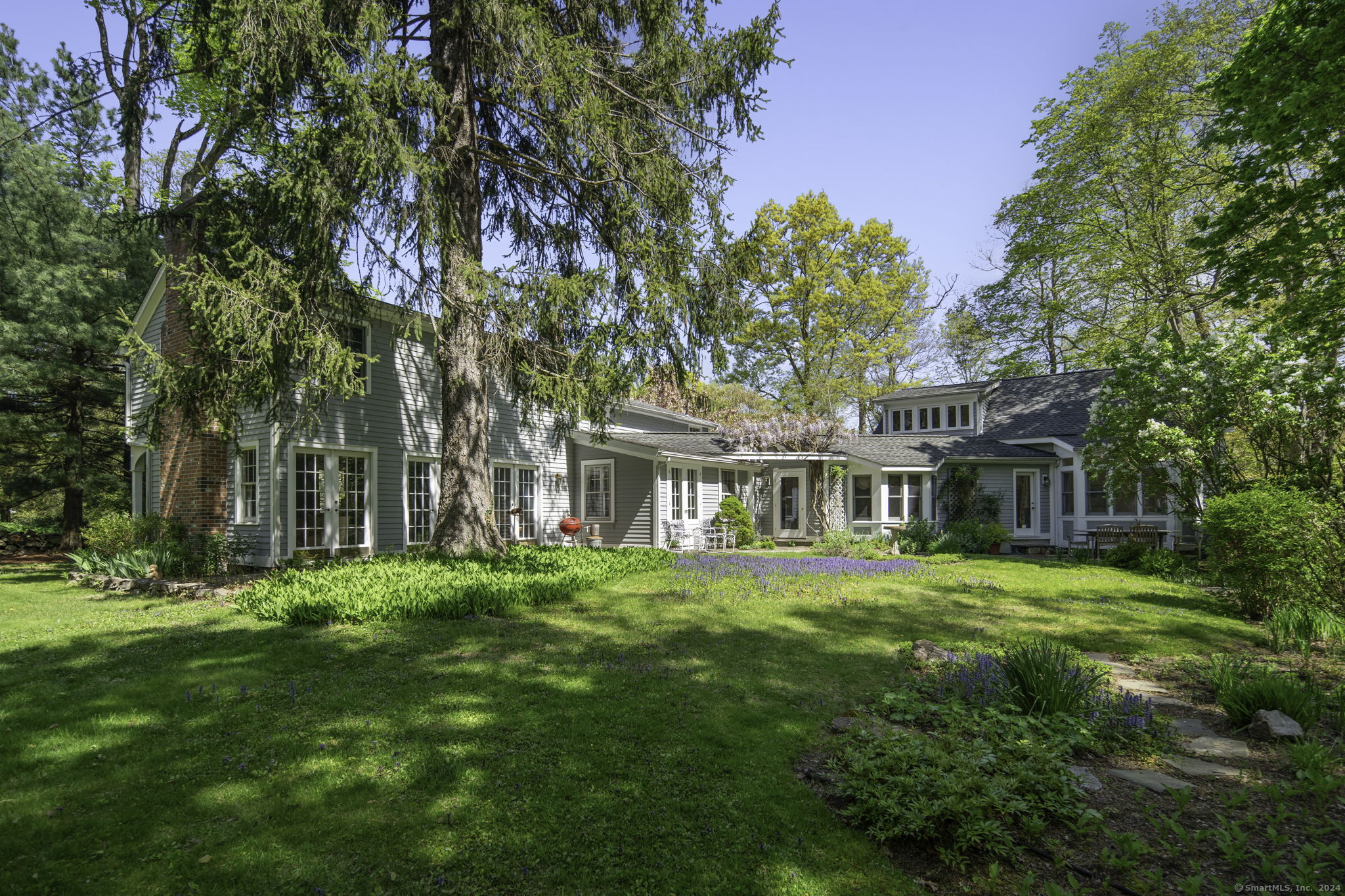 a front view of a house with a garden