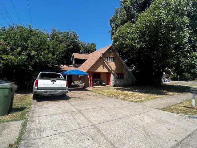 a view of a car parked in front of a house