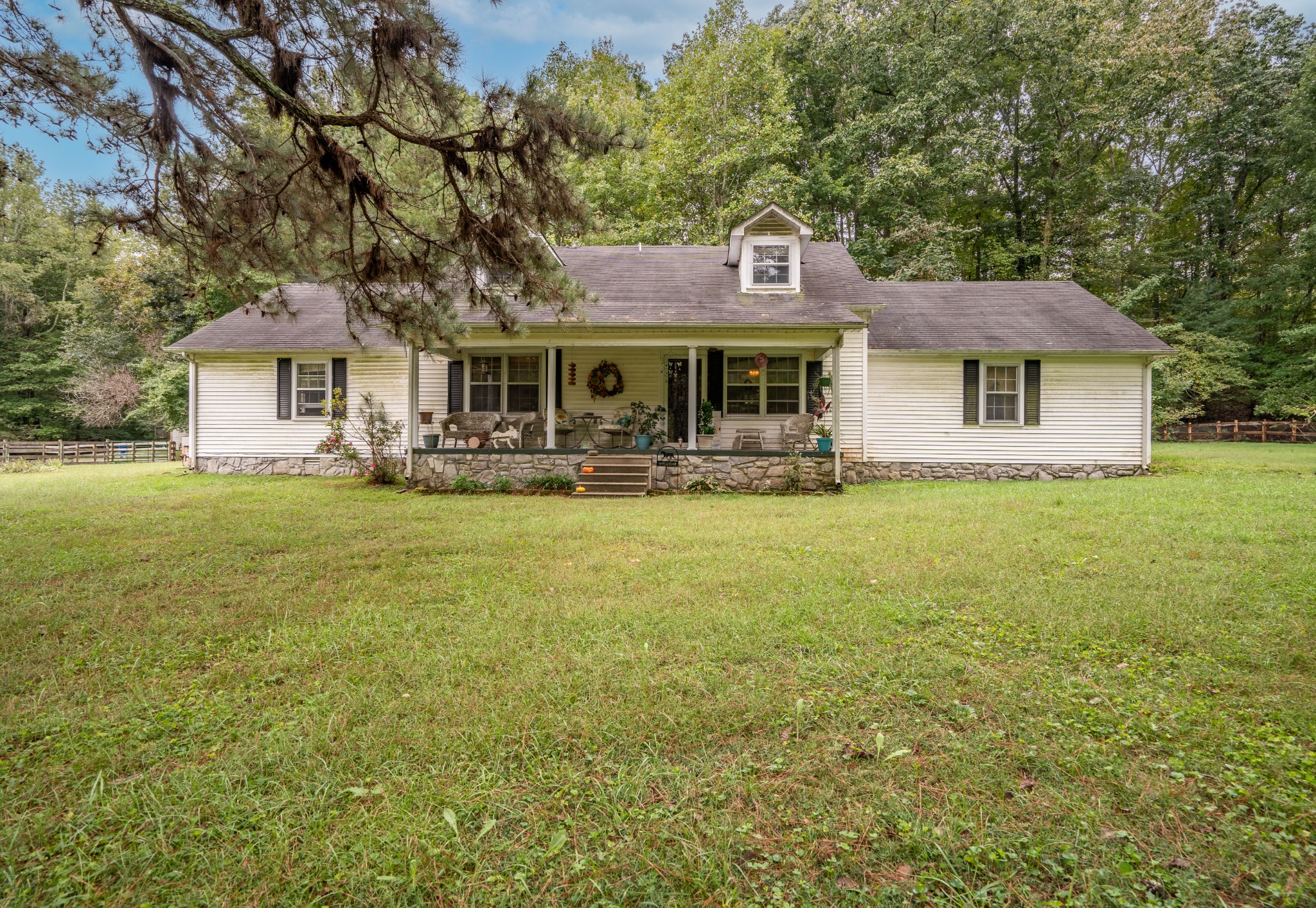 a front view of house with yard and trees around