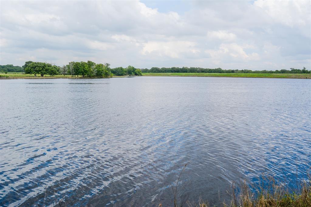 a view of a lake with houses in the back