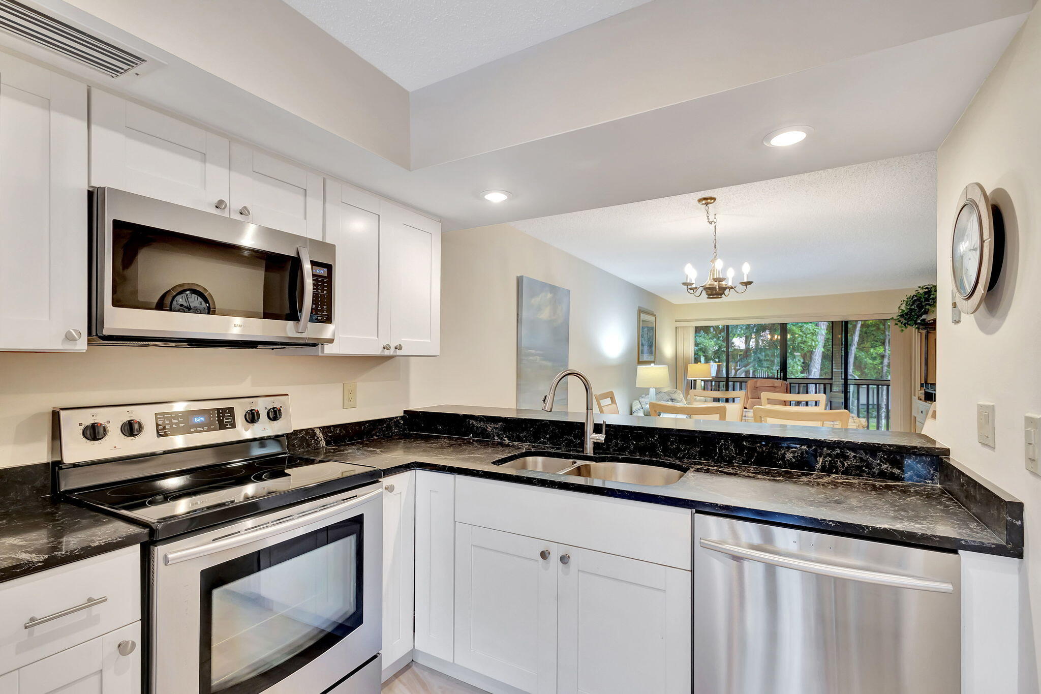 a kitchen with a sink stove and microwave