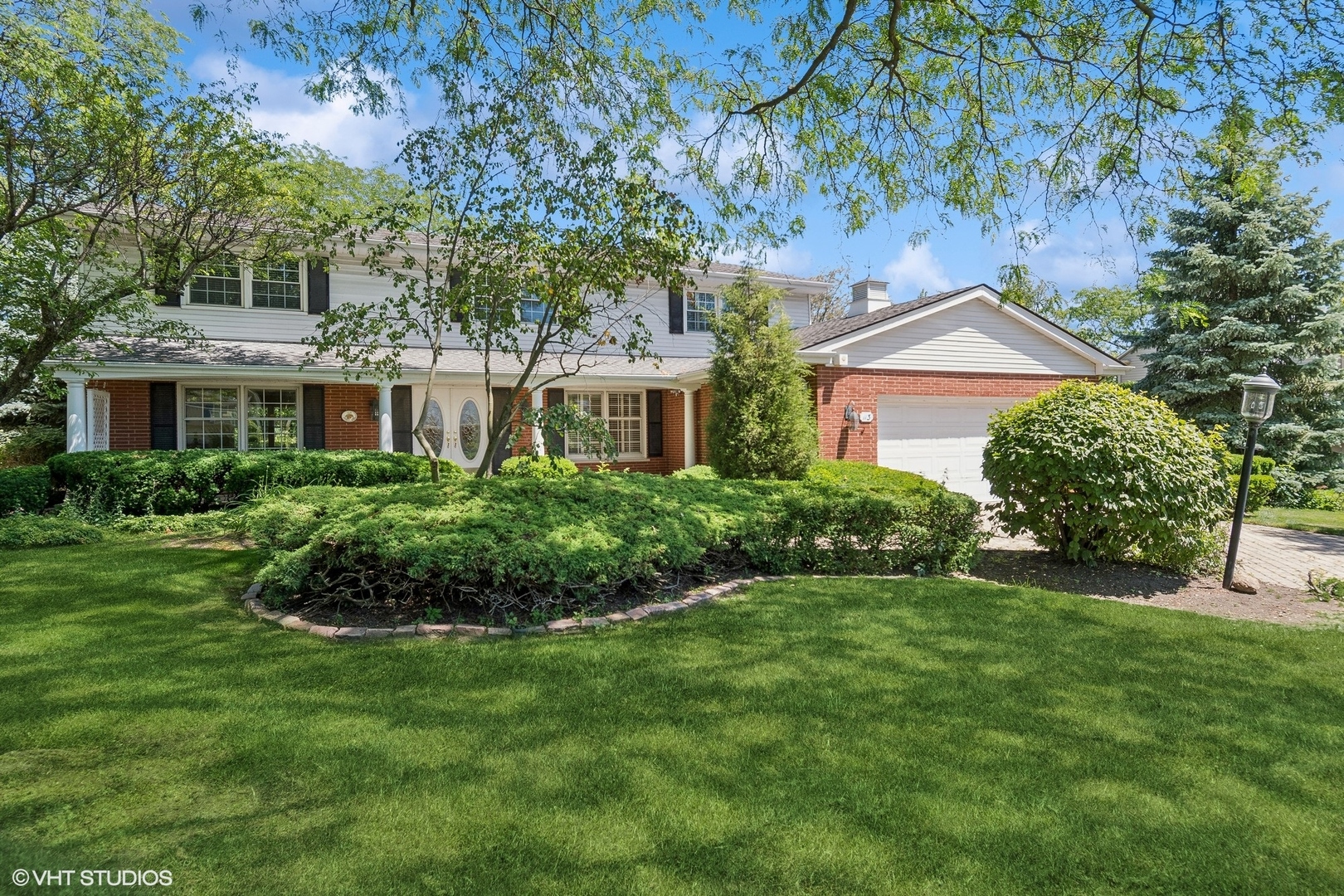 a front view of a house with a garden