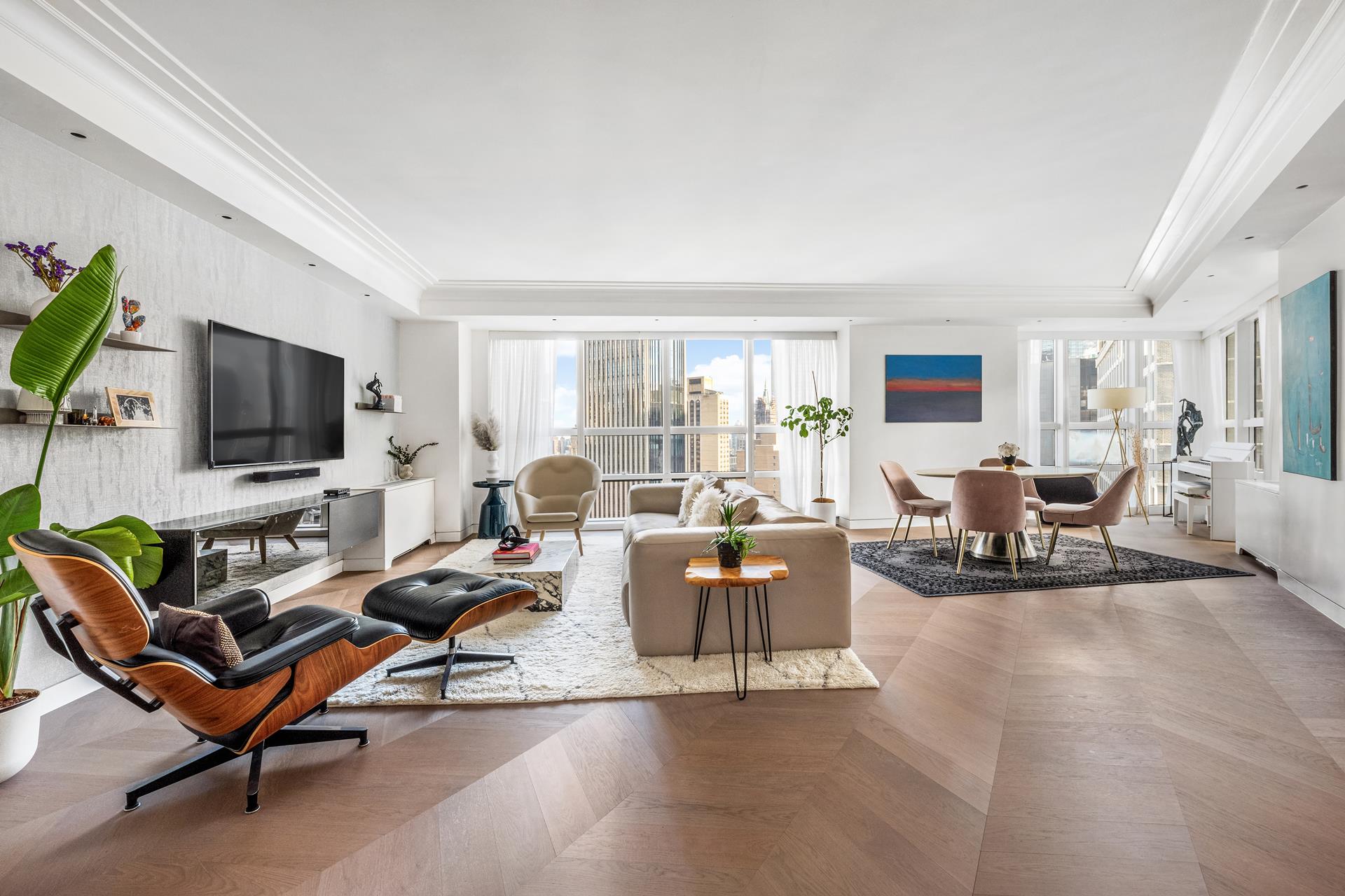 a living room with furniture a flat screen tv and a window