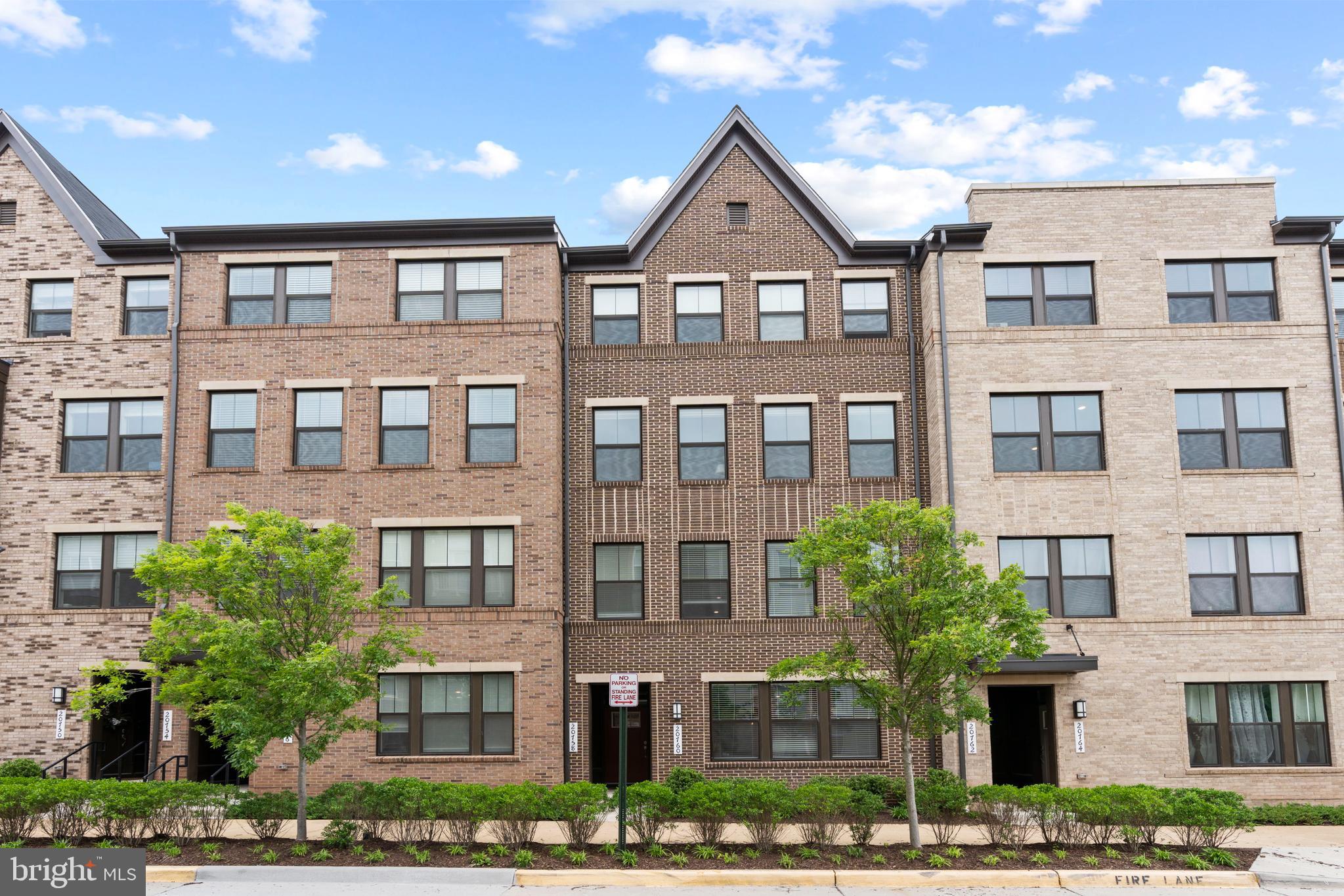 a front view of a residential apartment building with a yard