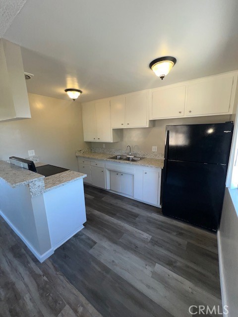 a kitchen with granite countertop a sink and cabinets