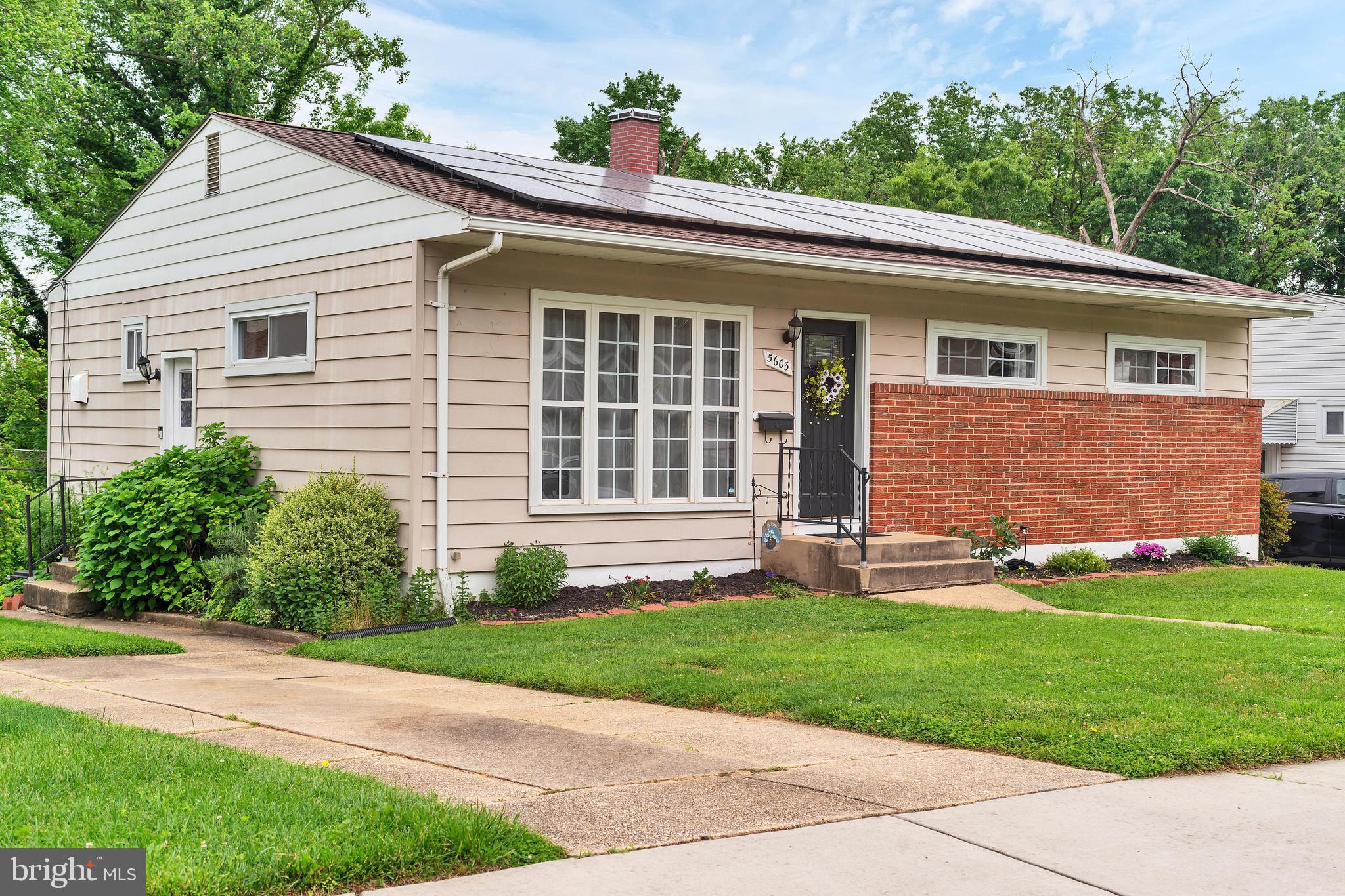 a front view of a house with a yard and a garage