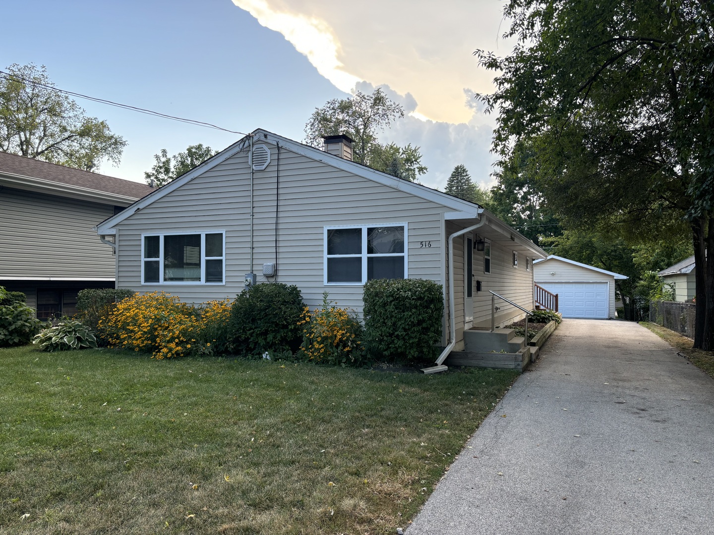 a view of a house with a yard and plants