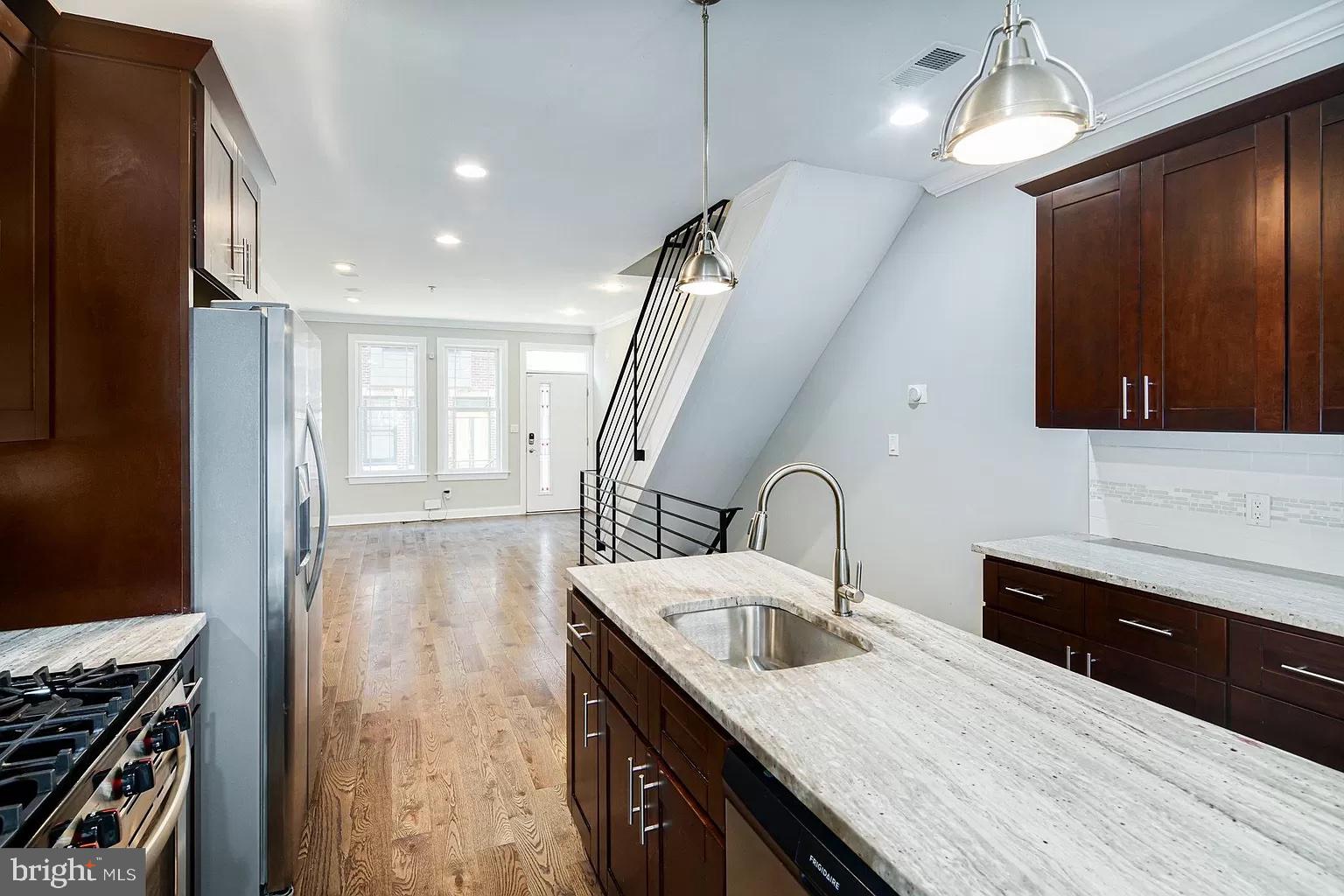 a kitchen with sink cabinets and stove