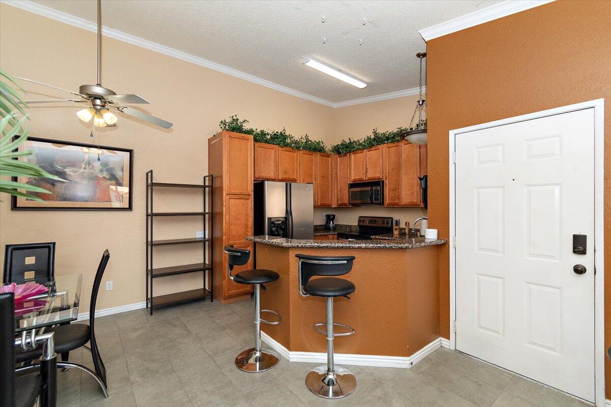 a view of a workspace with furniture and a kitchen