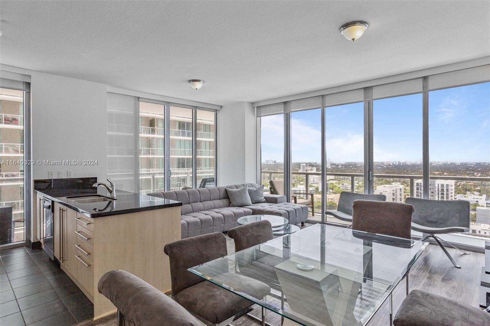 a living room with furniture and large windows