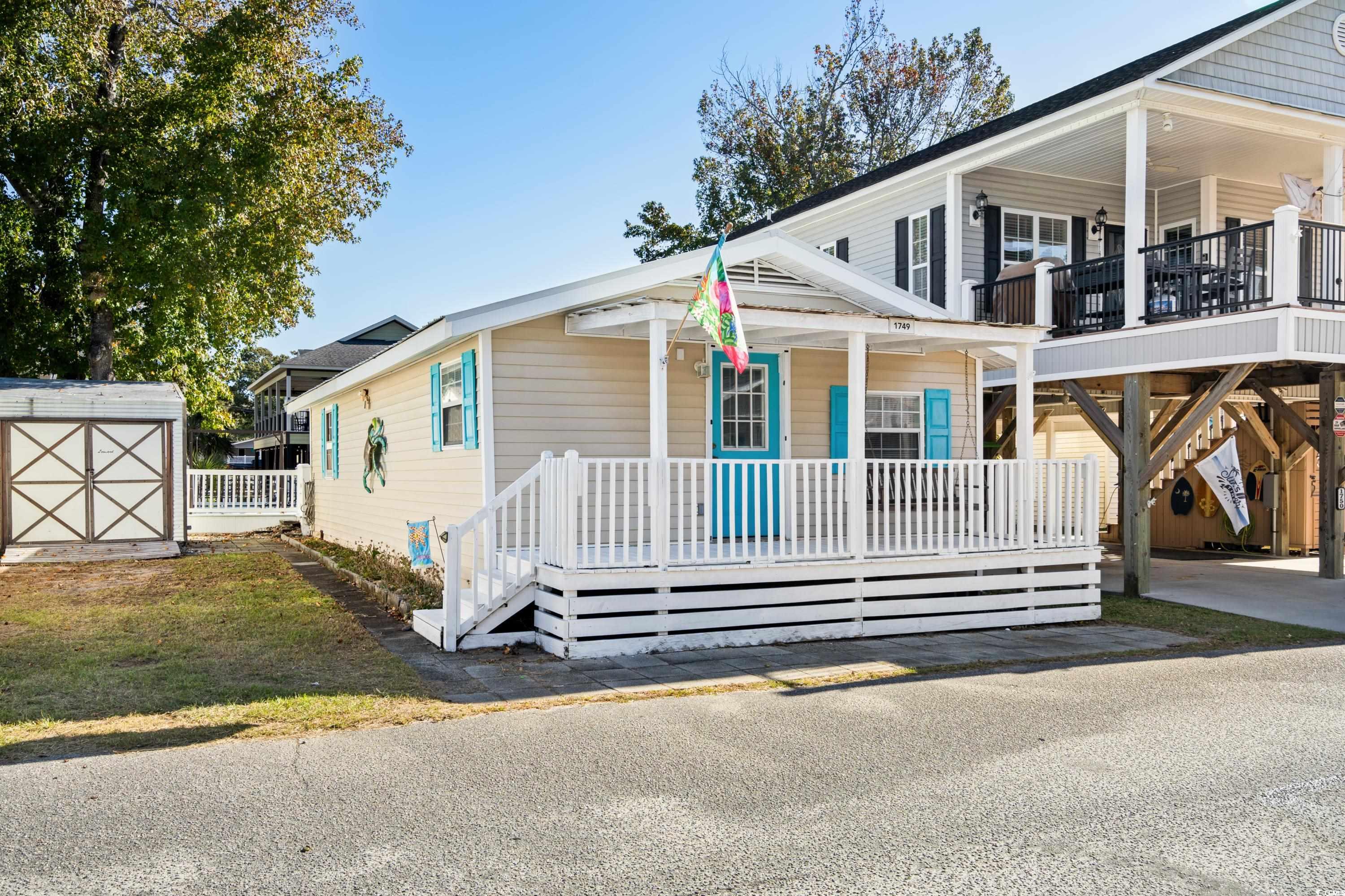 View of front of property featuring a deck and a s