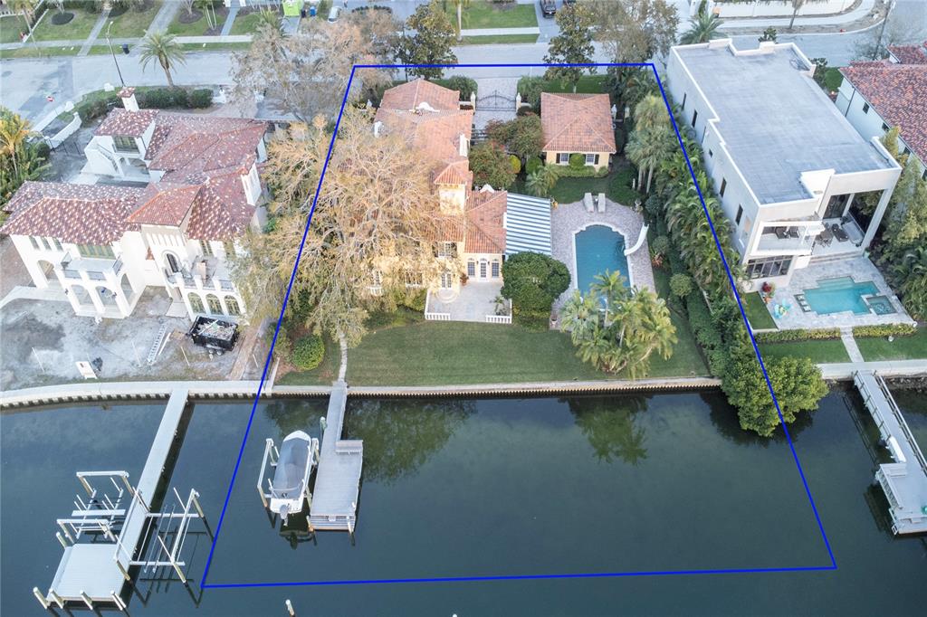 an aerial view of residential houses with outdoor space and parking