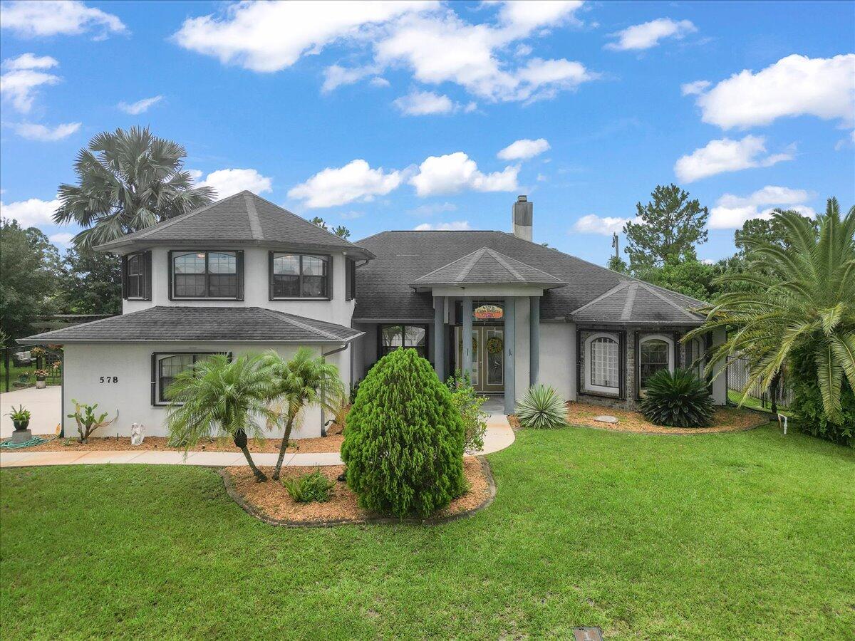 a front view of a house with a yard