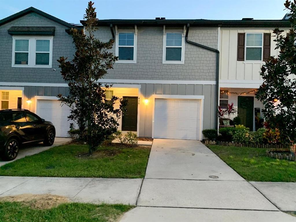 a front view of a house with a yard and garage