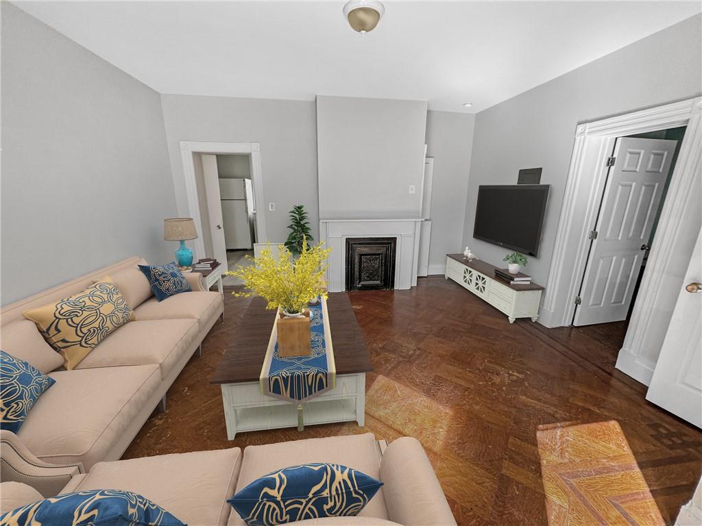 a living room with furniture a fireplace and a flat screen tv