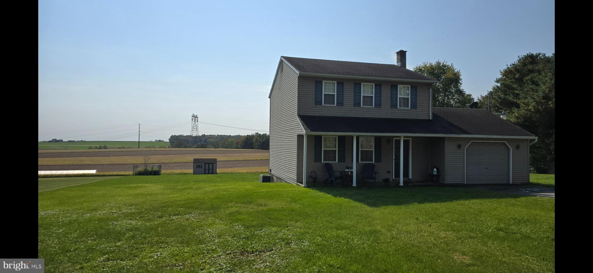 a view of a house with a yard and a garden