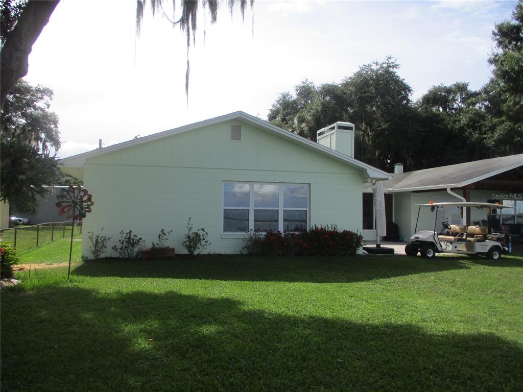 a front view of a house with a garden and yard