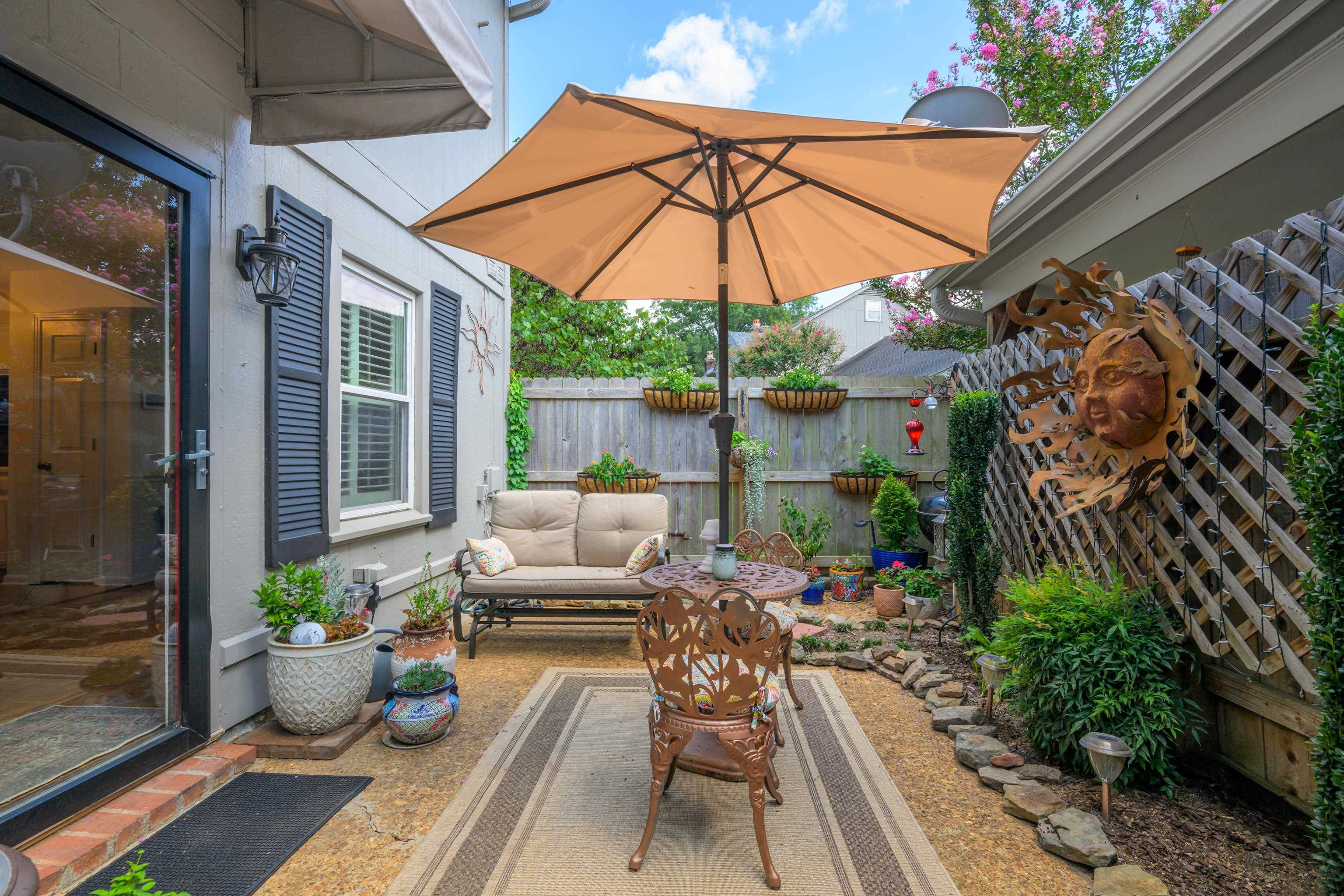 a patio with patio a table and chairs under an umbrella