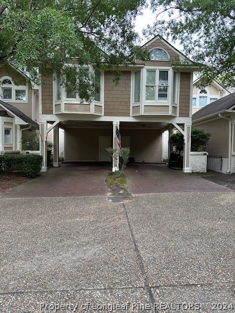 a view of a house with a yard and a garage