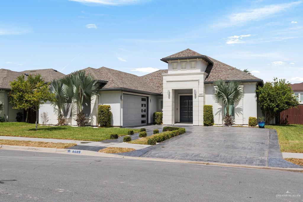 a front view of a house with a yard and garage