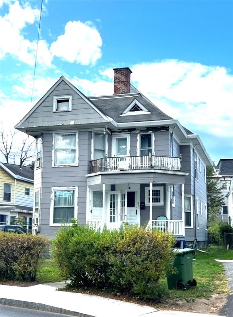 a front view of a house with yard and green space