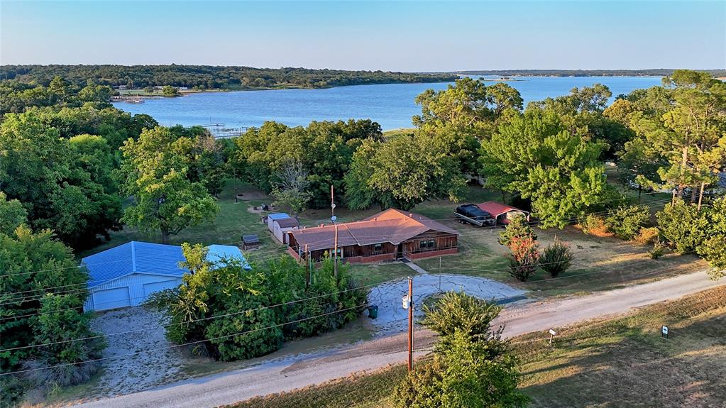 an aerial view of a house with a garden and lake view