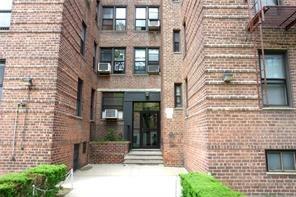 a front view of a brick building with many windows