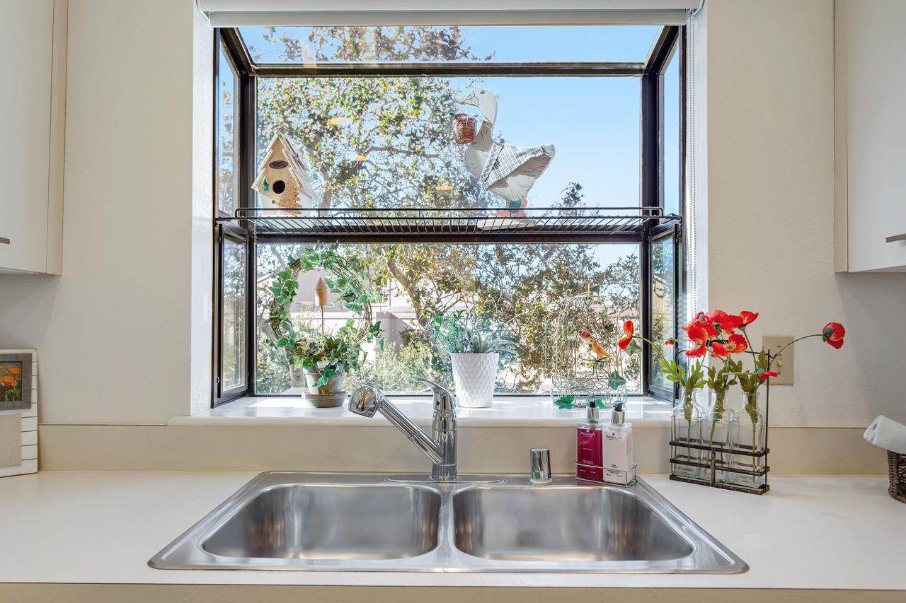 a view of a faucet a sink and a window