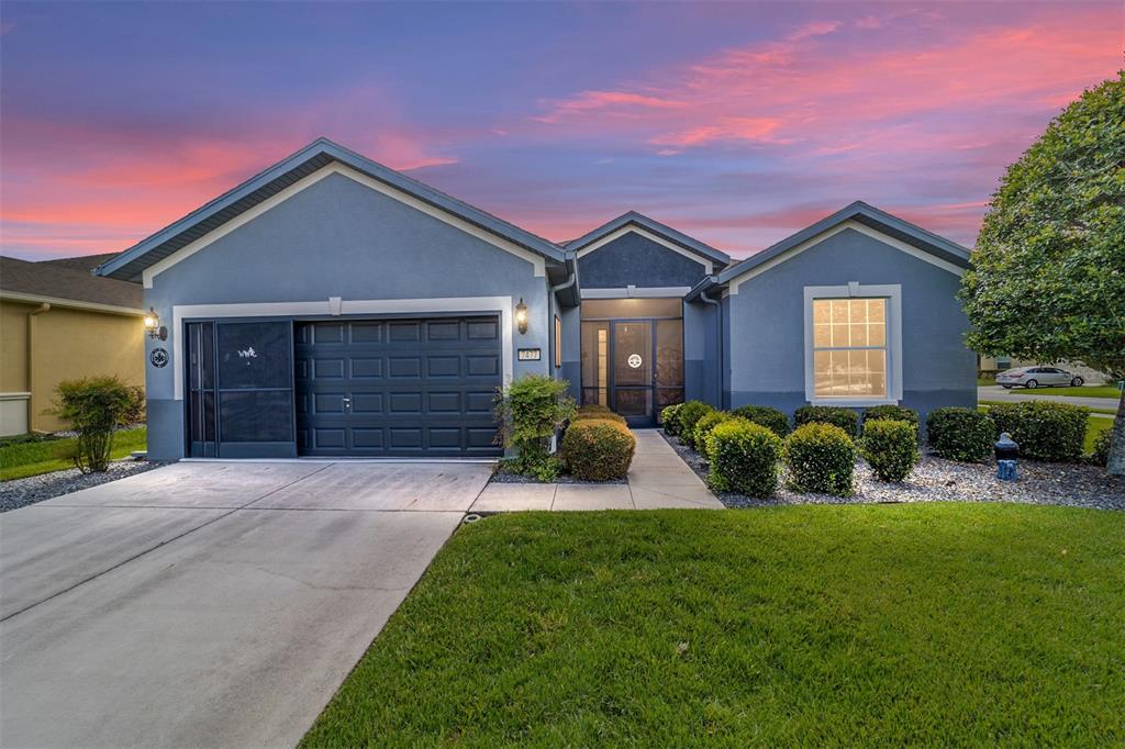 a front view of a house with a yard and garage