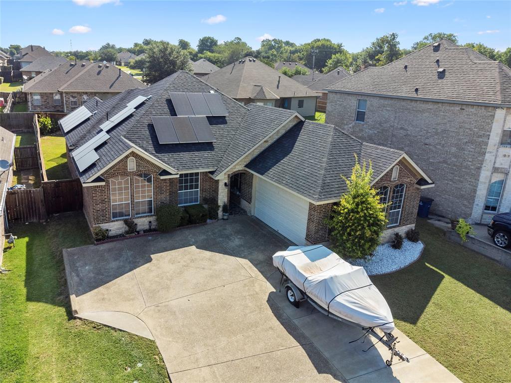 an aerial view of a house with a big yard