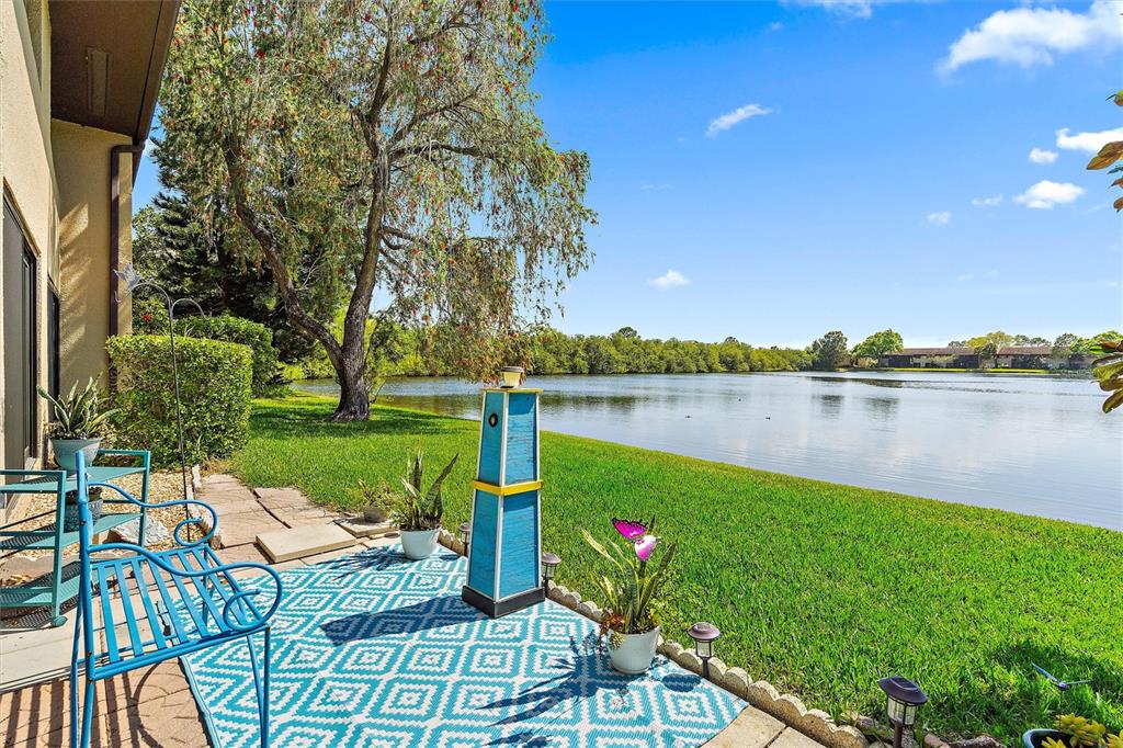 a view of a lake with a table and chairs