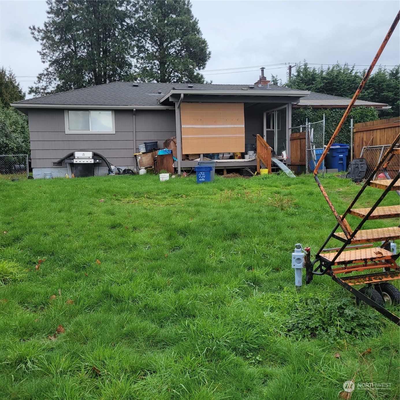 a front view of a house with swing and a yard