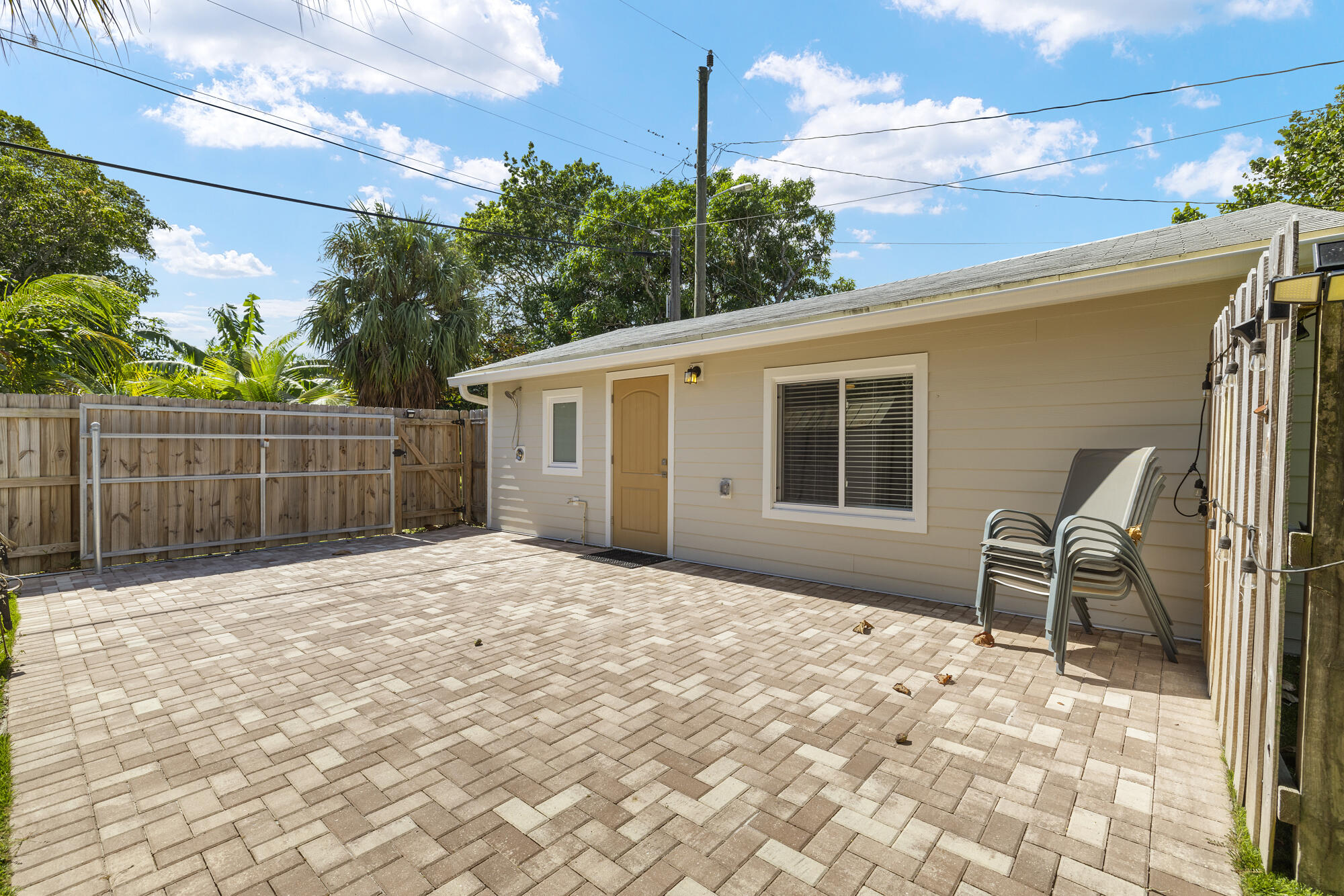 a backyard of a house with table and chairs