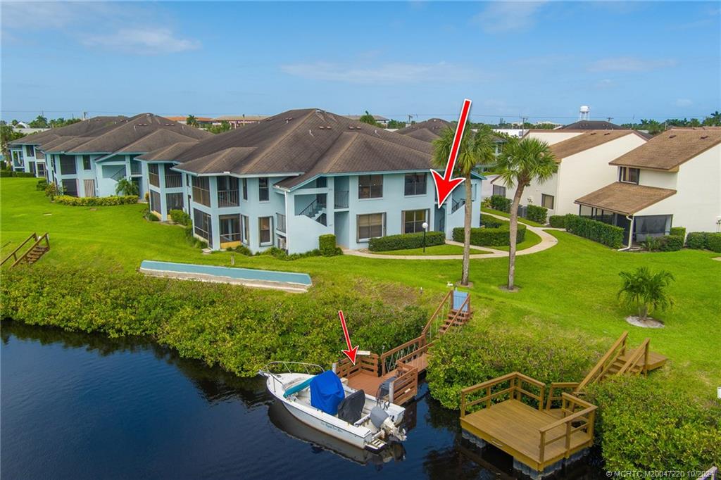 an aerial view of a house with swimming pool garden and lake view